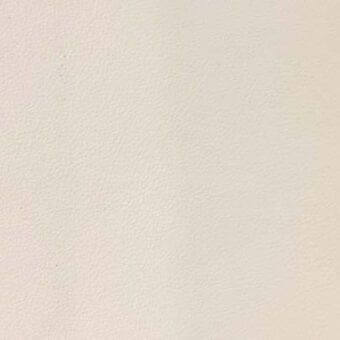 Leather rug, light beige, rectangular shape with a smooth, granular texture and consistent tone presented in a studio setting.